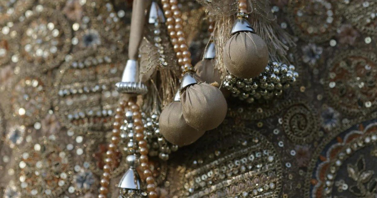 Close-up of bead and sequin embroidery on fabric with pearl beaded tassels