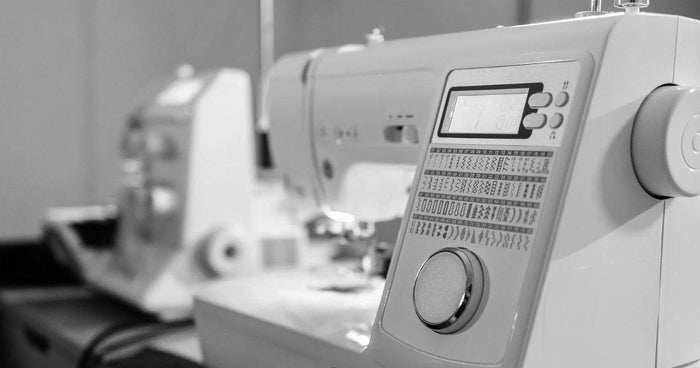 Close-up of a computerized home sewing machine with decorative stitch settings for embroidery