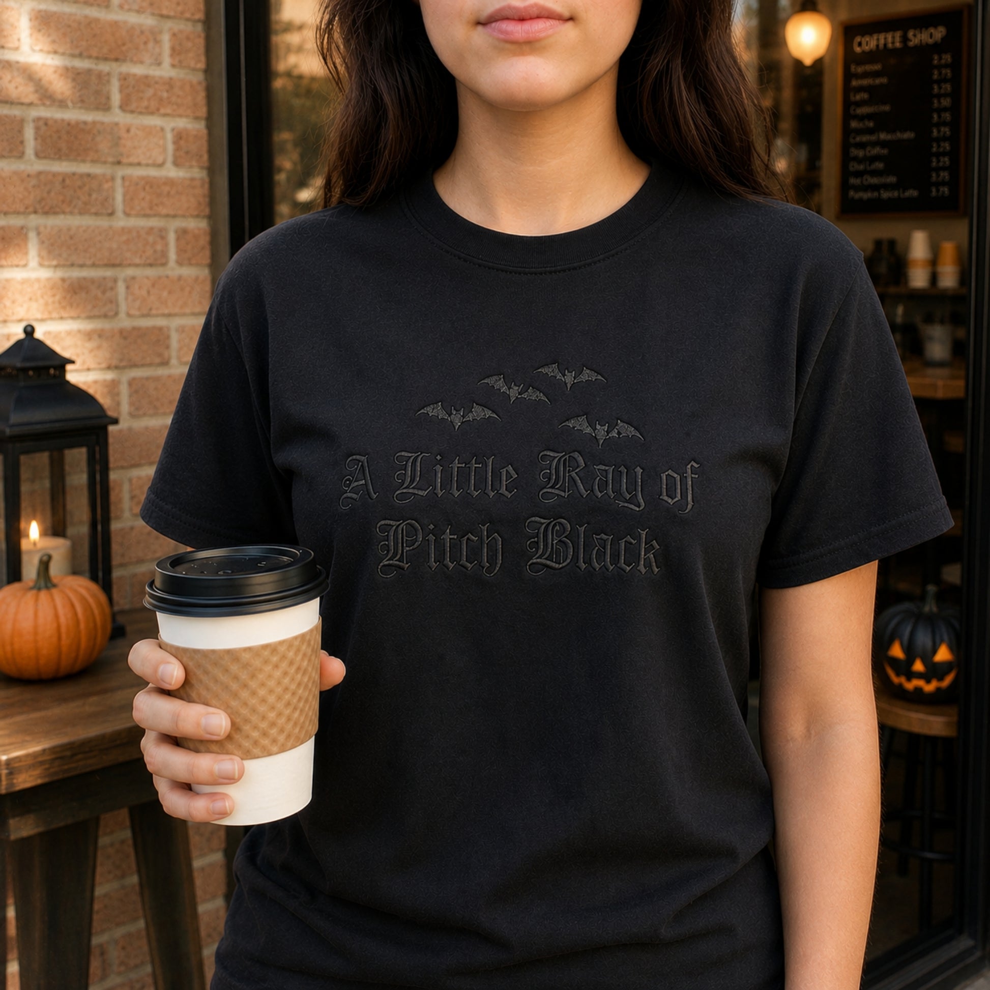 Black on black embroidered t-shirt featuring the A Little Ray of Pitch Black gothic design with embroidered bats, styled for spooky season, Halloween outfits, and minimalist gothic fashion.