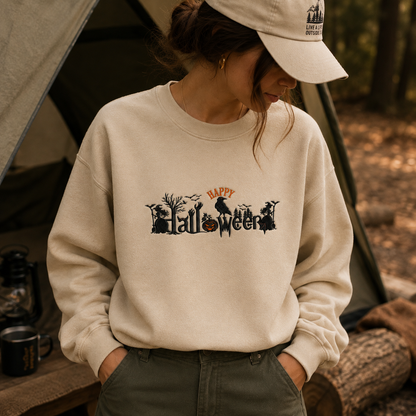 A woman wearing a cream-colored crewneck sweatshirt with a black 'Halloween' graphic and orange 'Happy' text, styled in an outdoor camping setting with a tent in the background.