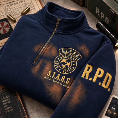 Navy quarter-zip sweatshirt with gold embroidered S.T.A.R.S. Raccoon Police Department emblem and R.P.D. sleeve lettering, displayed with tactical-themed props.